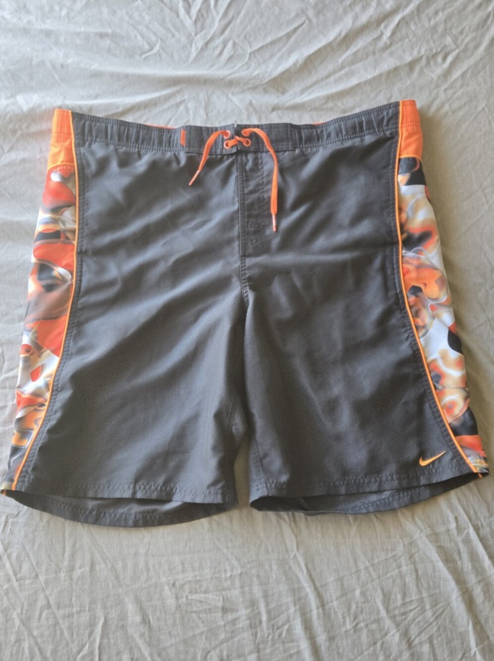 Nike Men’s Black Board Shorts with Orange Accents and Patterned Side Panels
